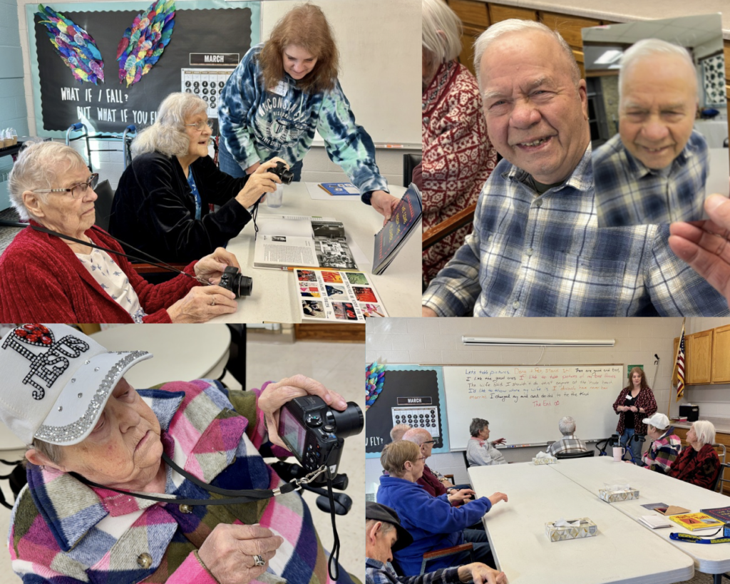 A collage of photos from a COMPAS photography workshop at Elim Oasis Adult Day Center. Older adult participants sit around tables using digital cameras, smiling, and reviewing photo books. One man holds a printed photo of himself and smiles. A woman in a colorful patchwork jacket and white hat focuses intently on her camera. In another image, a group gathers around a whiteboard where a collaborative story is written. A staff member stands nearby, engaging with the group.